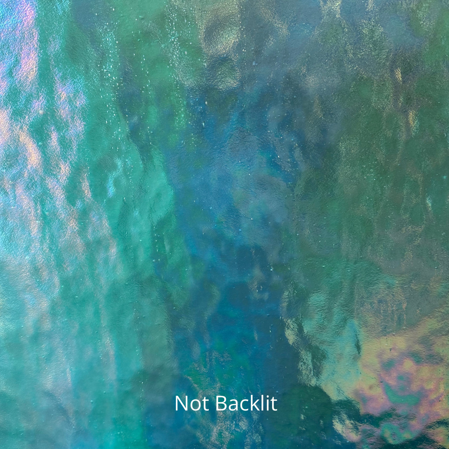 A non-backlit photo of blue iridescent stained glass.