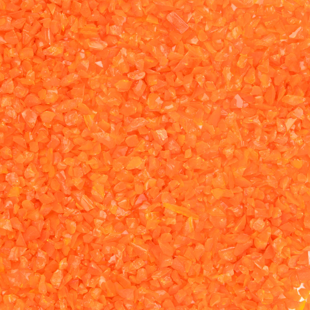 Close-up of an orange opalescent glass frit texture.