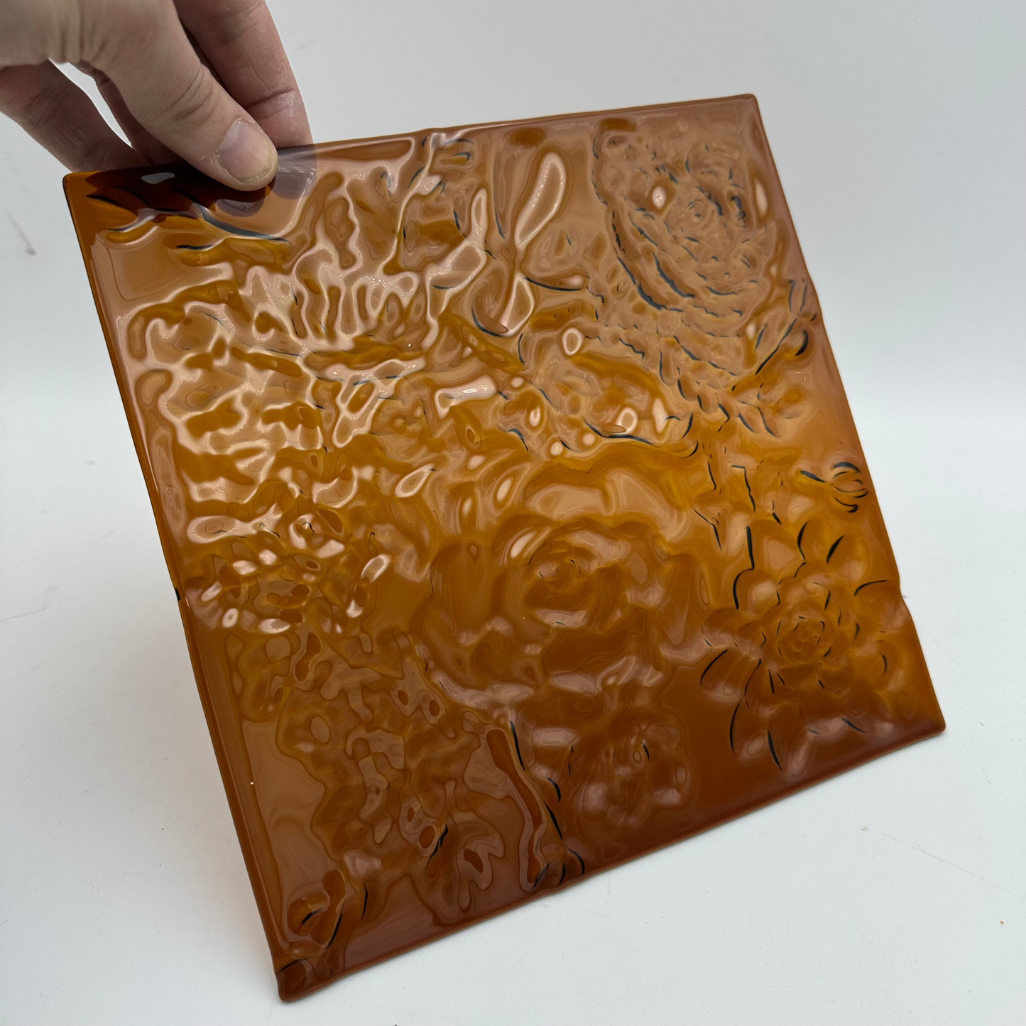 Bronze fused glass with a floral texture.