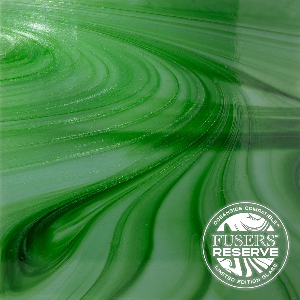 A green stained glass sheet with green sparkly swirls.