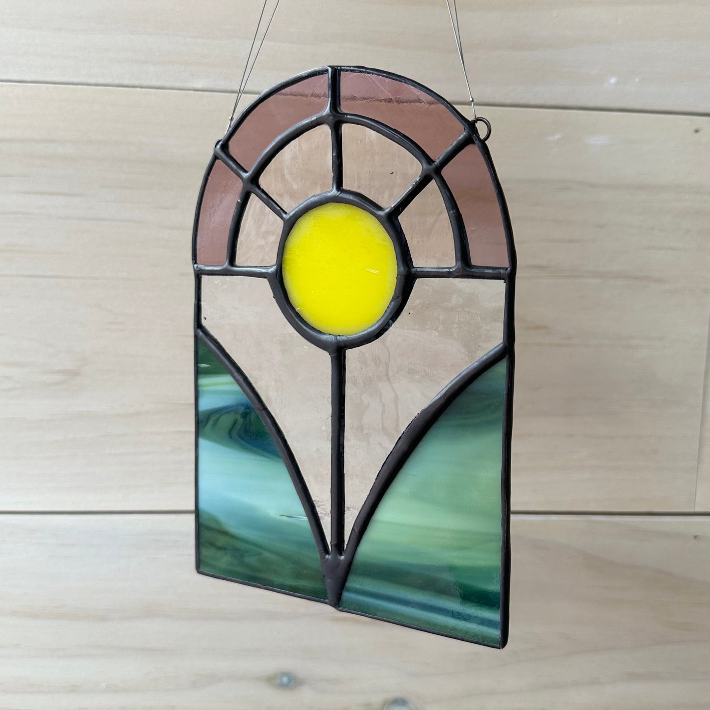 A floral stained glass sun-catcher.