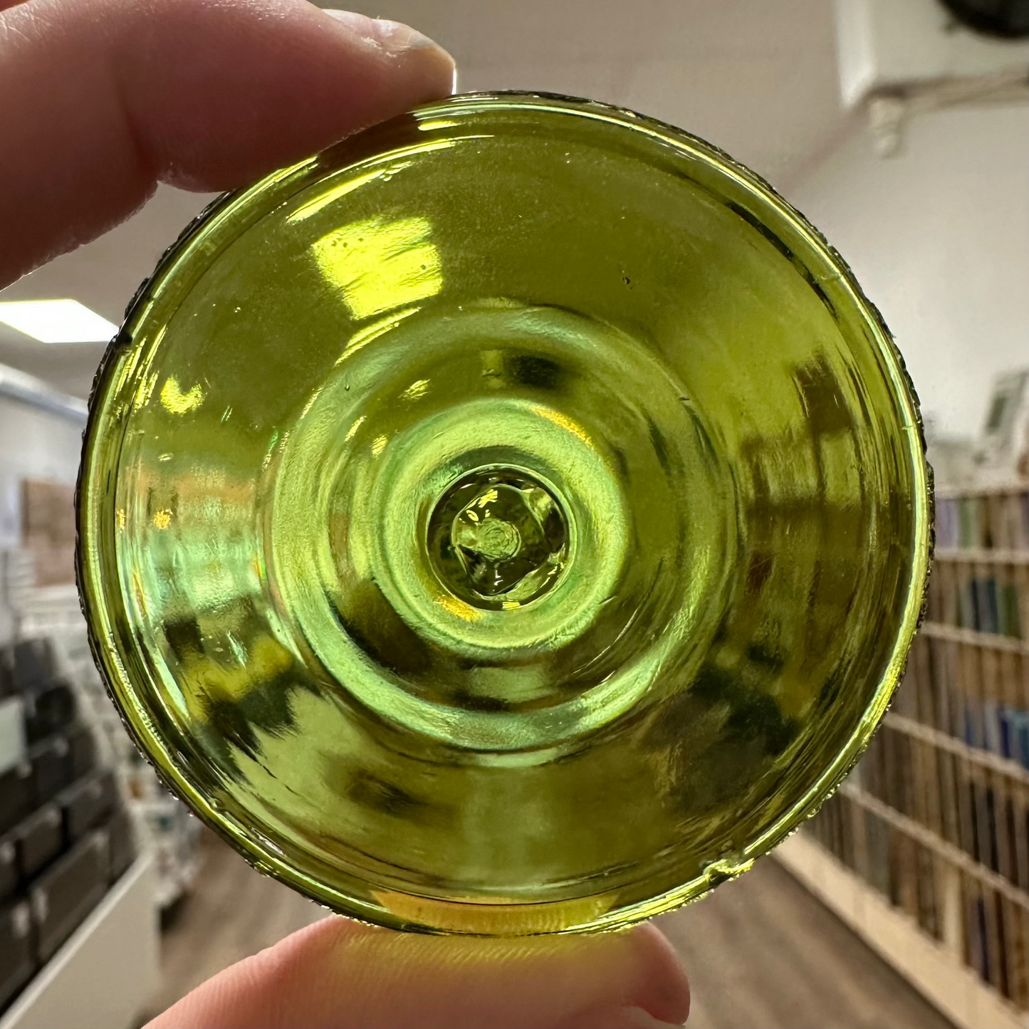 An olive green glass rondel.