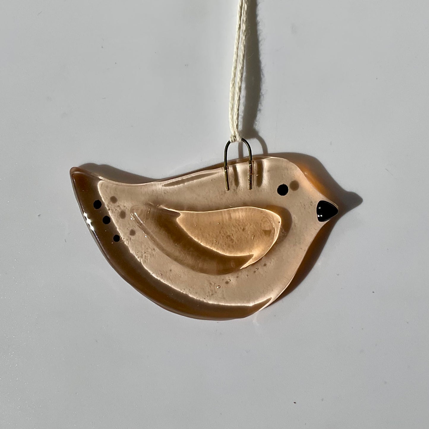 Fused glass suncatcher of a pink bird.