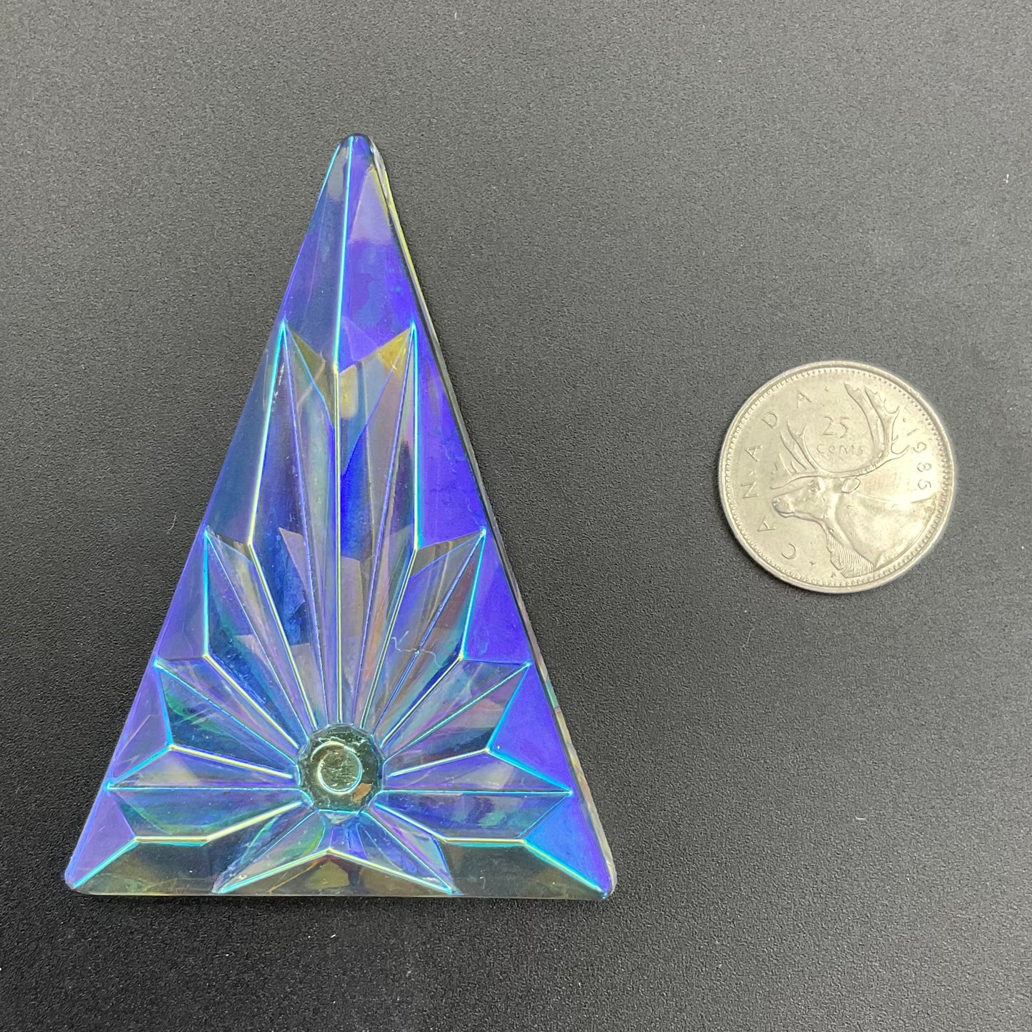 A large textured trichroic triangle glass jewel.