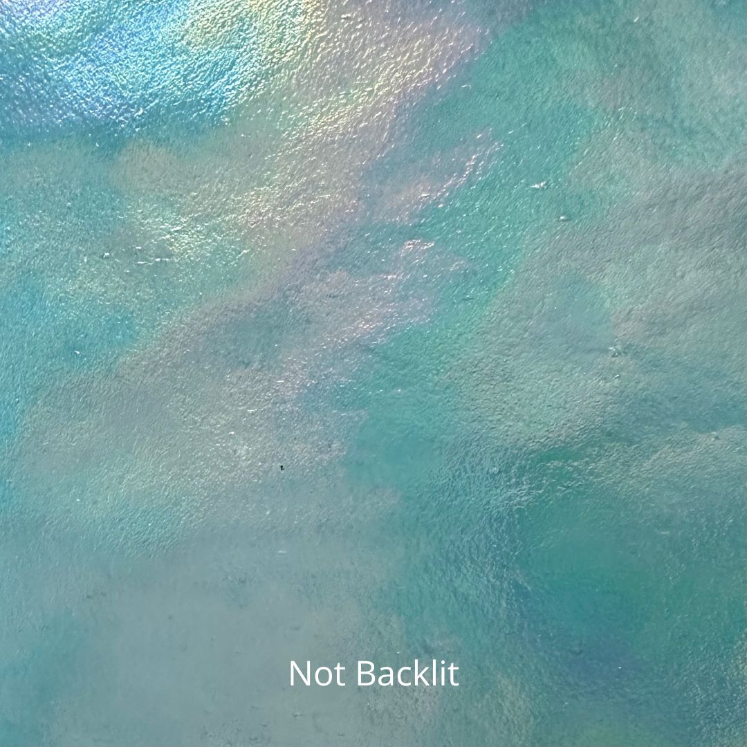 A not backlit photo of a blue piece of iridescent stained glass.