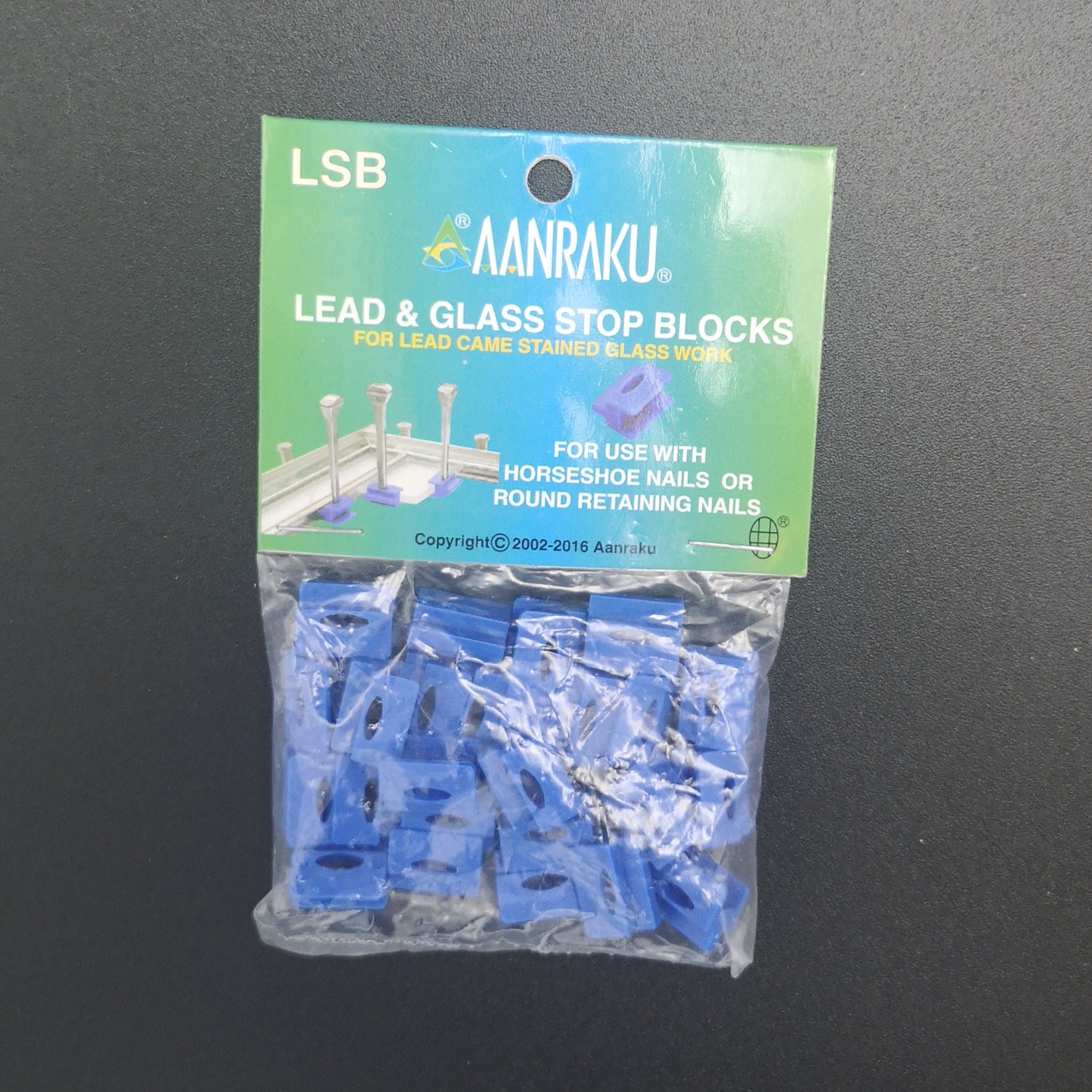 Lead stop blocks for holding glass while making stained glass windows.