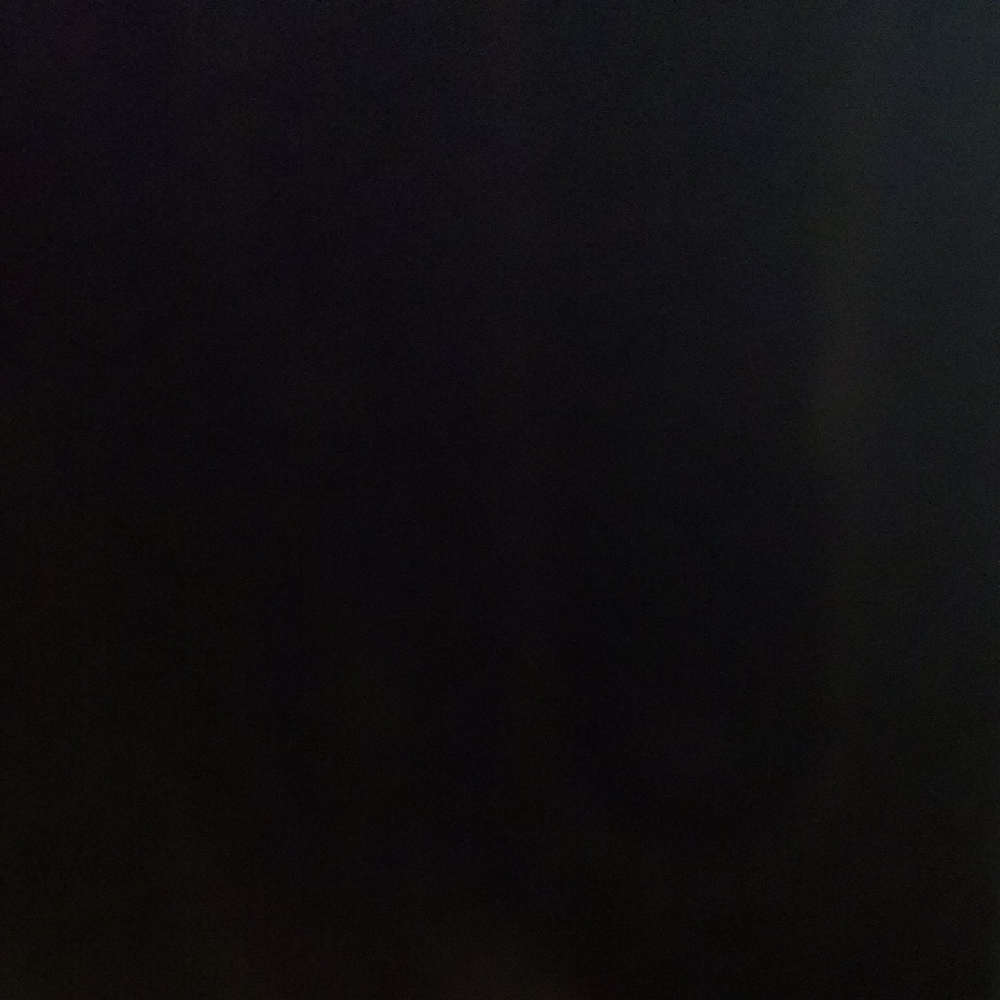 A sheet of black opal smooth fusible glass.