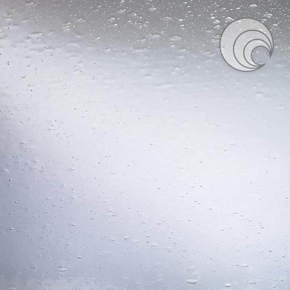 A sheet of clear seedy fusible glass with a textured surface, typically used in arts and crafts for fusion projects.