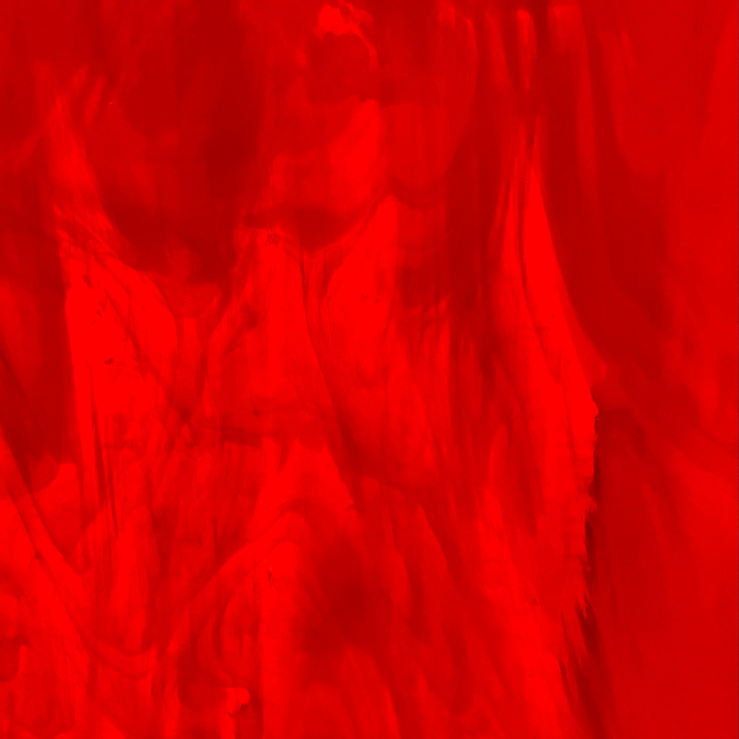 A sheet of red, semi-translucent, smooth fusible art glass.