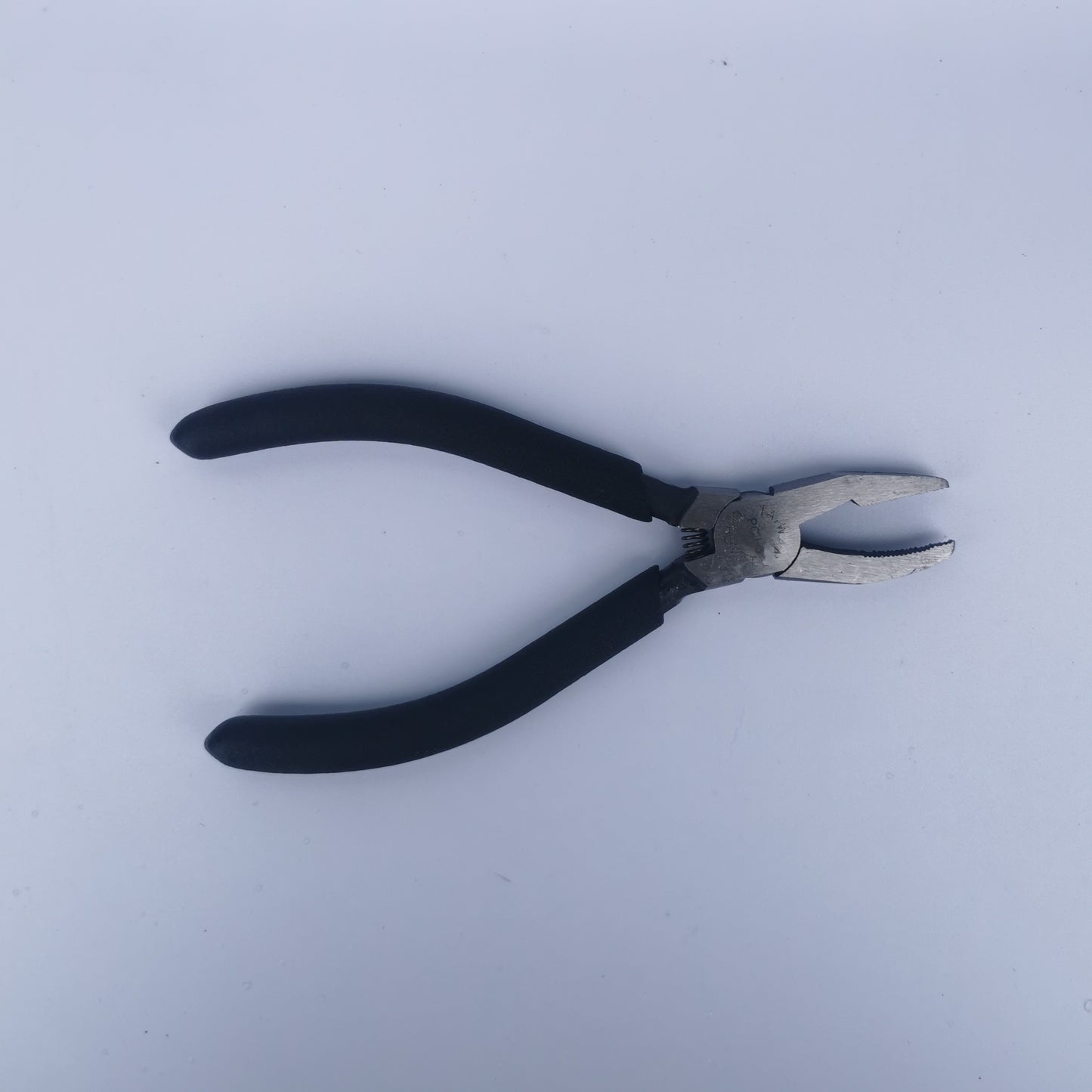A pair of narrow nose grozing pliers for stained glass.