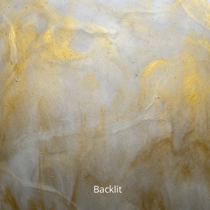 A backlit photo of a sheet of amber and white glass for stained glass.