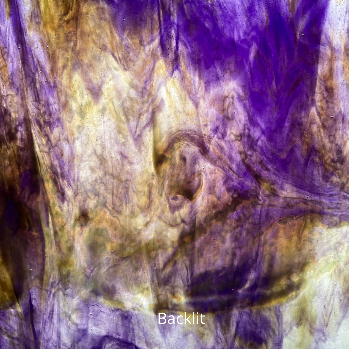 A backlit photo of purple and yellow sheet glass.