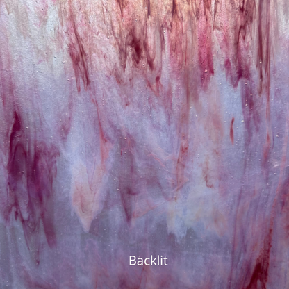 A backlit photo of white glass with pink streaks.