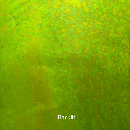 A backlit sheet of green iridescent stained glass.