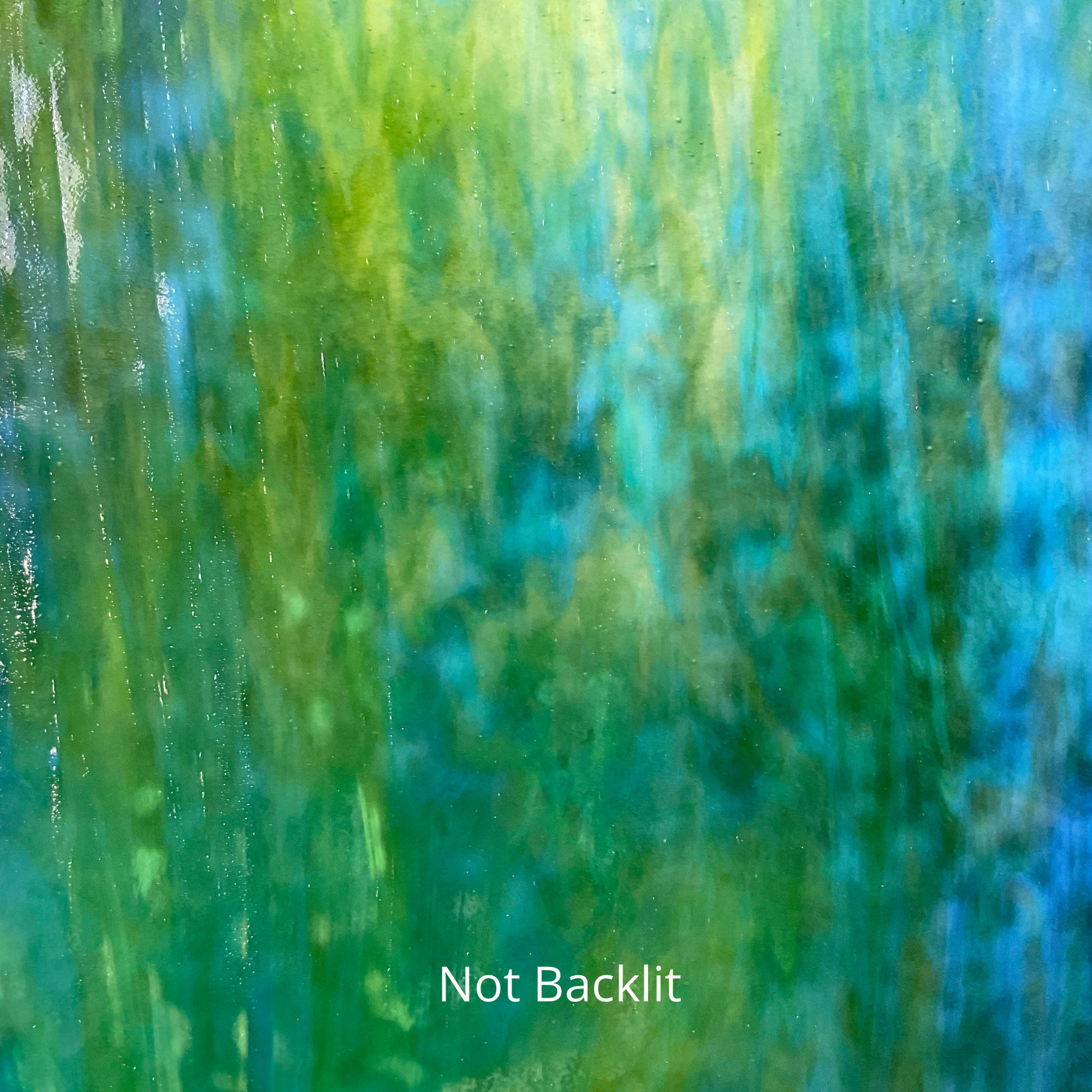A blue and green sheet of art glass for stained glass.