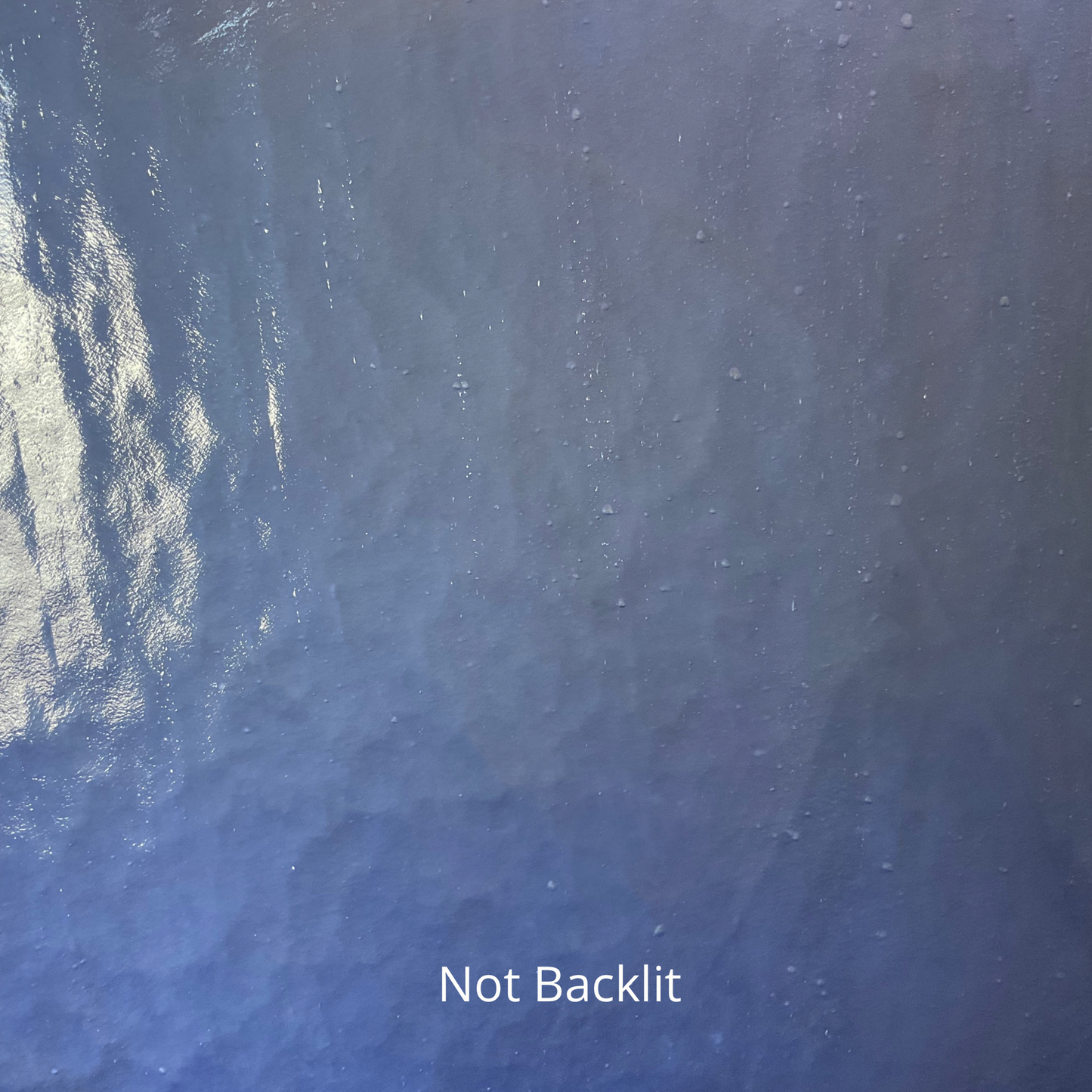 A not backlit photo of a piece of blue stained glass.