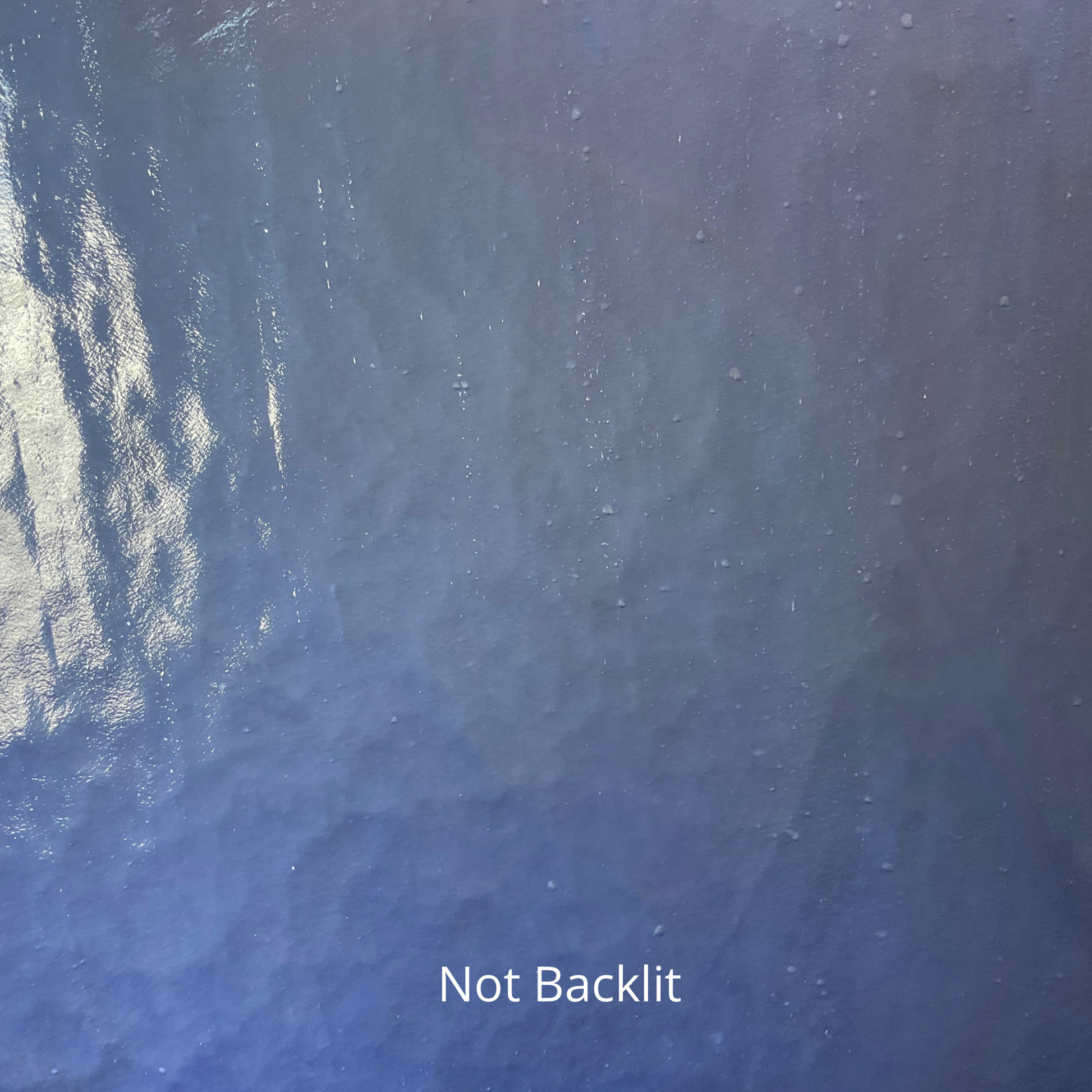A not backlit photo of a piece of blue stained glass.