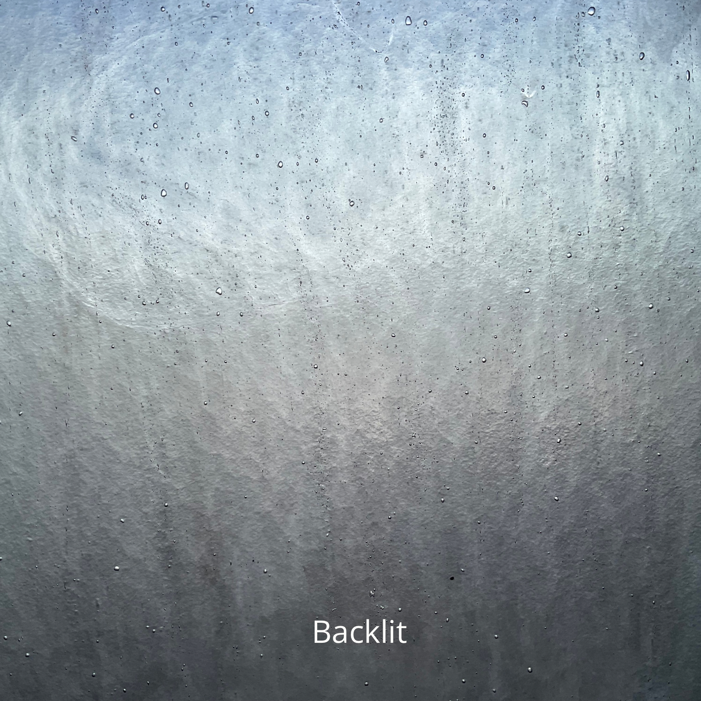A backlit photo of grey glass used for stained glass projects.
