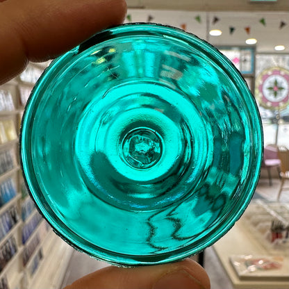 A blue green glass rondel for stained glass.