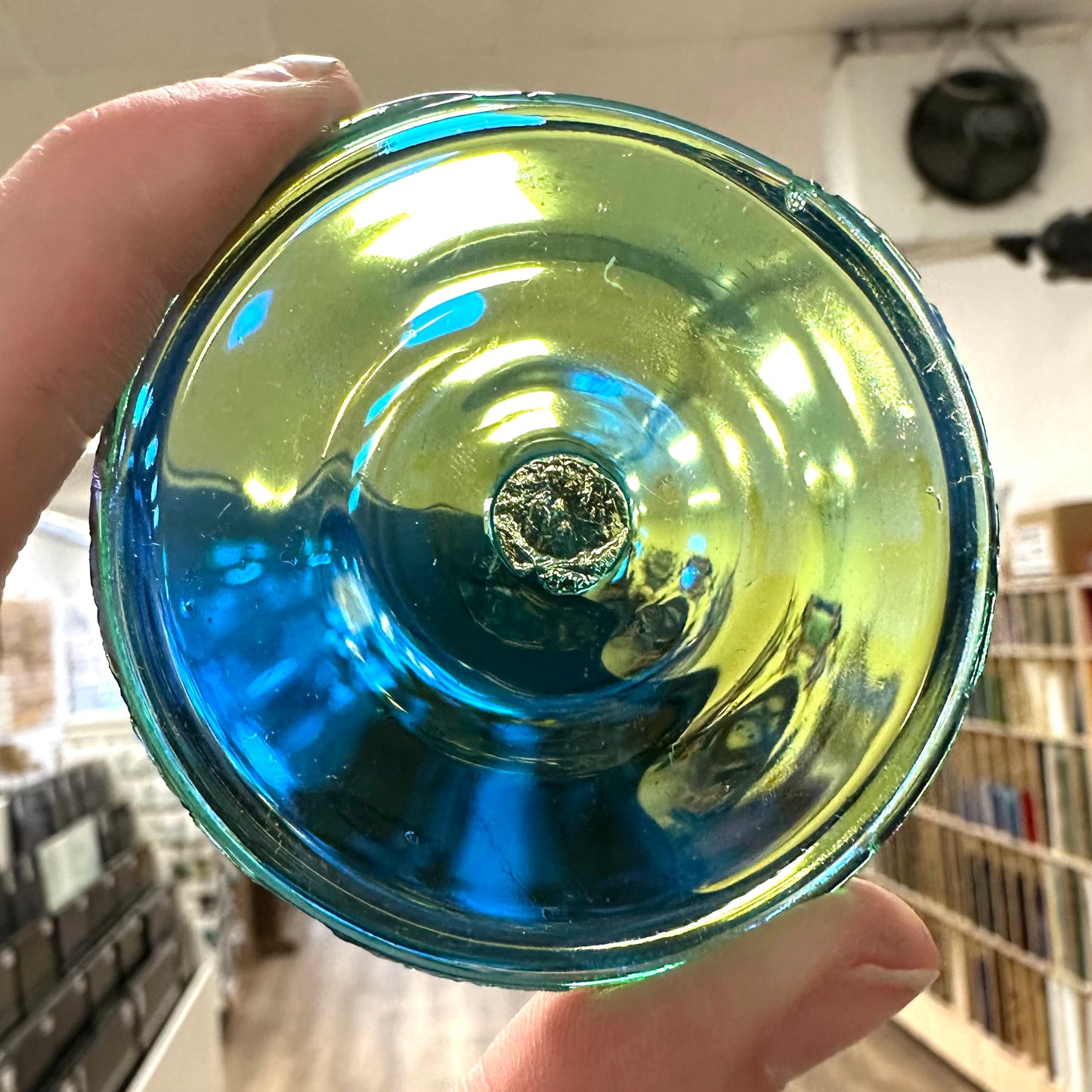 A blue green iridescent rondel for stained glass.
