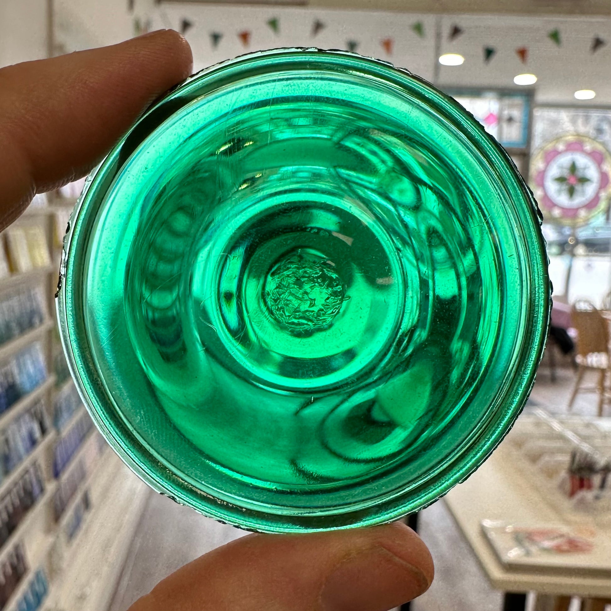 An emerald green glass rondel for stained glass.