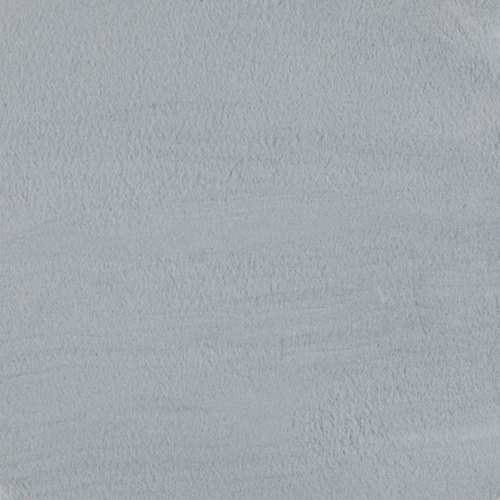 A close-up texture swatch of a light blue-gray plaster or stucco surface.
