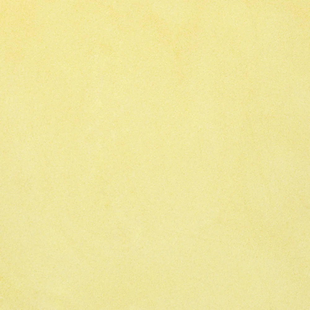 A close-up view of yellow transparent frit, commonly used in glass crafting.