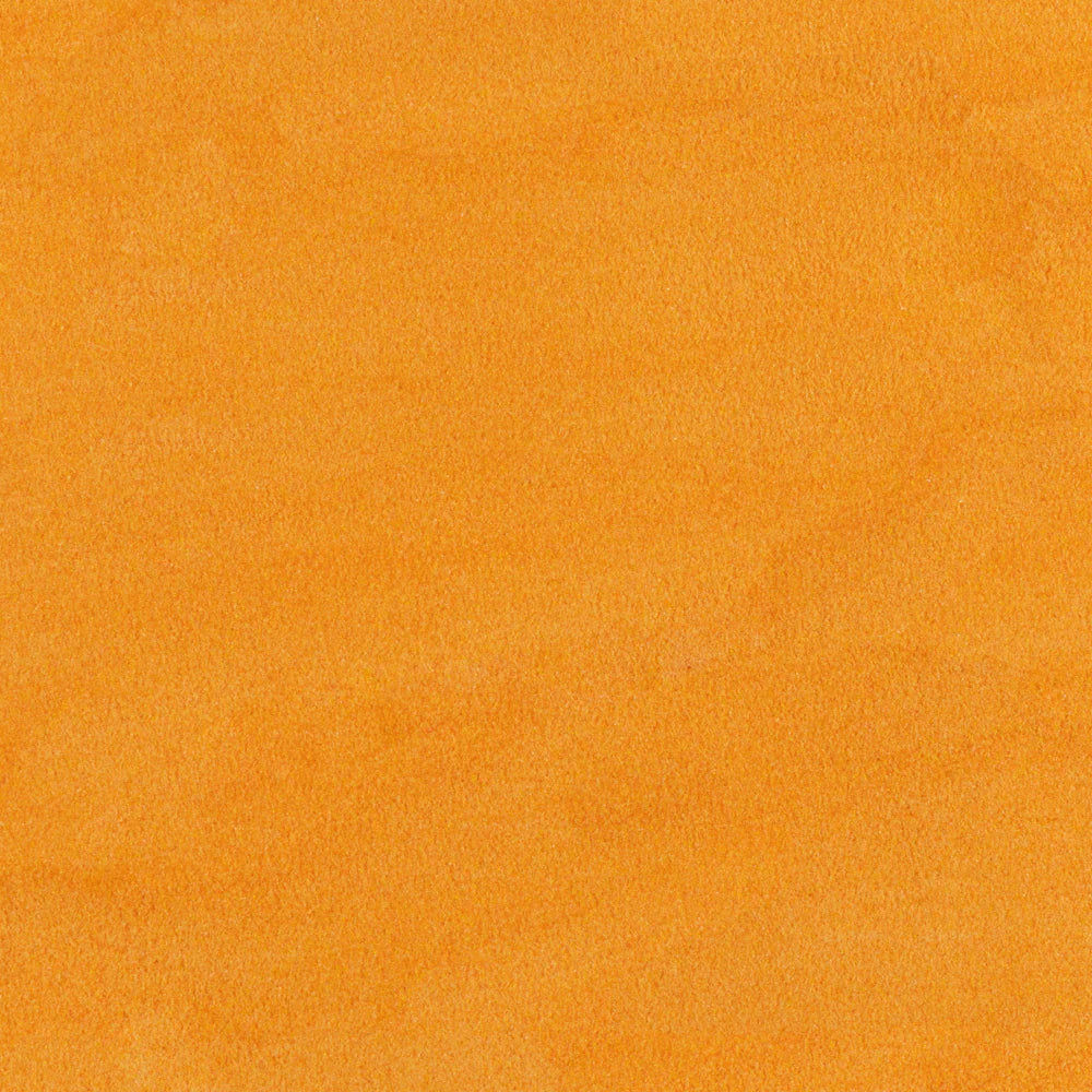 Close-up view of an orange transparent frit used in glass crafting.