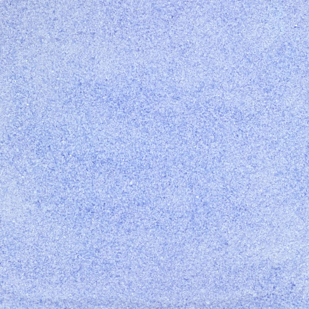 A close-up texture swatch of light blue fabric or material with a fine, mottled grain.