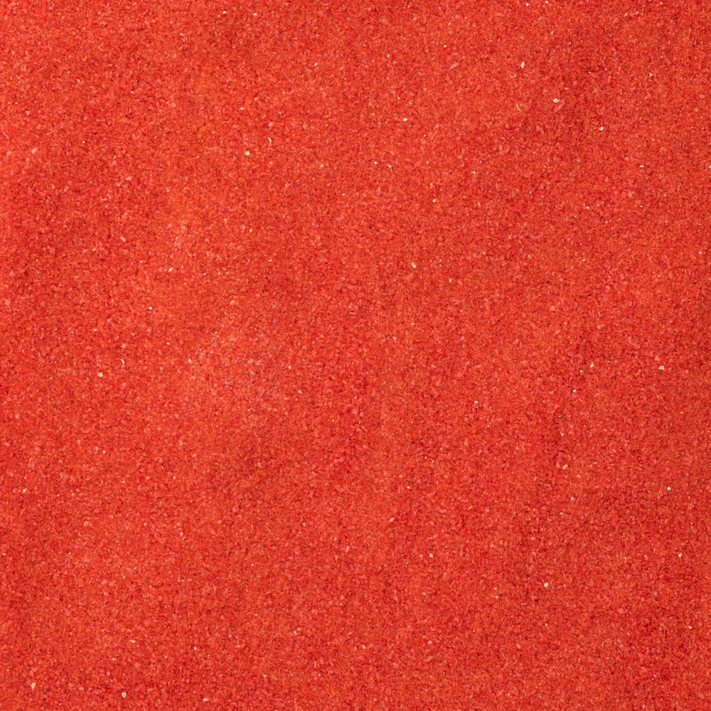 Close-up of an orange-colored System 96 frit, typically used for glass crafting.