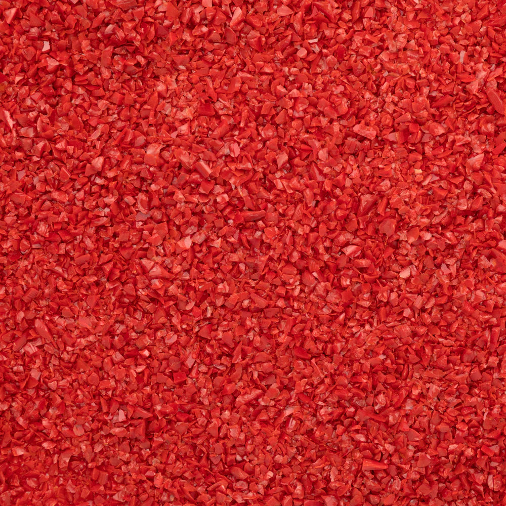 Close-up of an orange-colored System 96 frit, typically used for glass crafting.