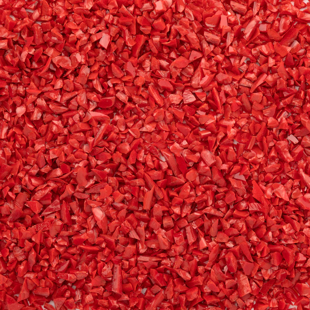 Close-up of an orange-colored System 96 frit, typically used for glass crafting.