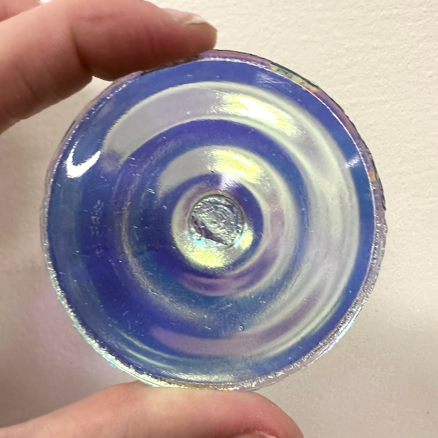 A light aquamarine iridescent glass rondel for stained glass.
