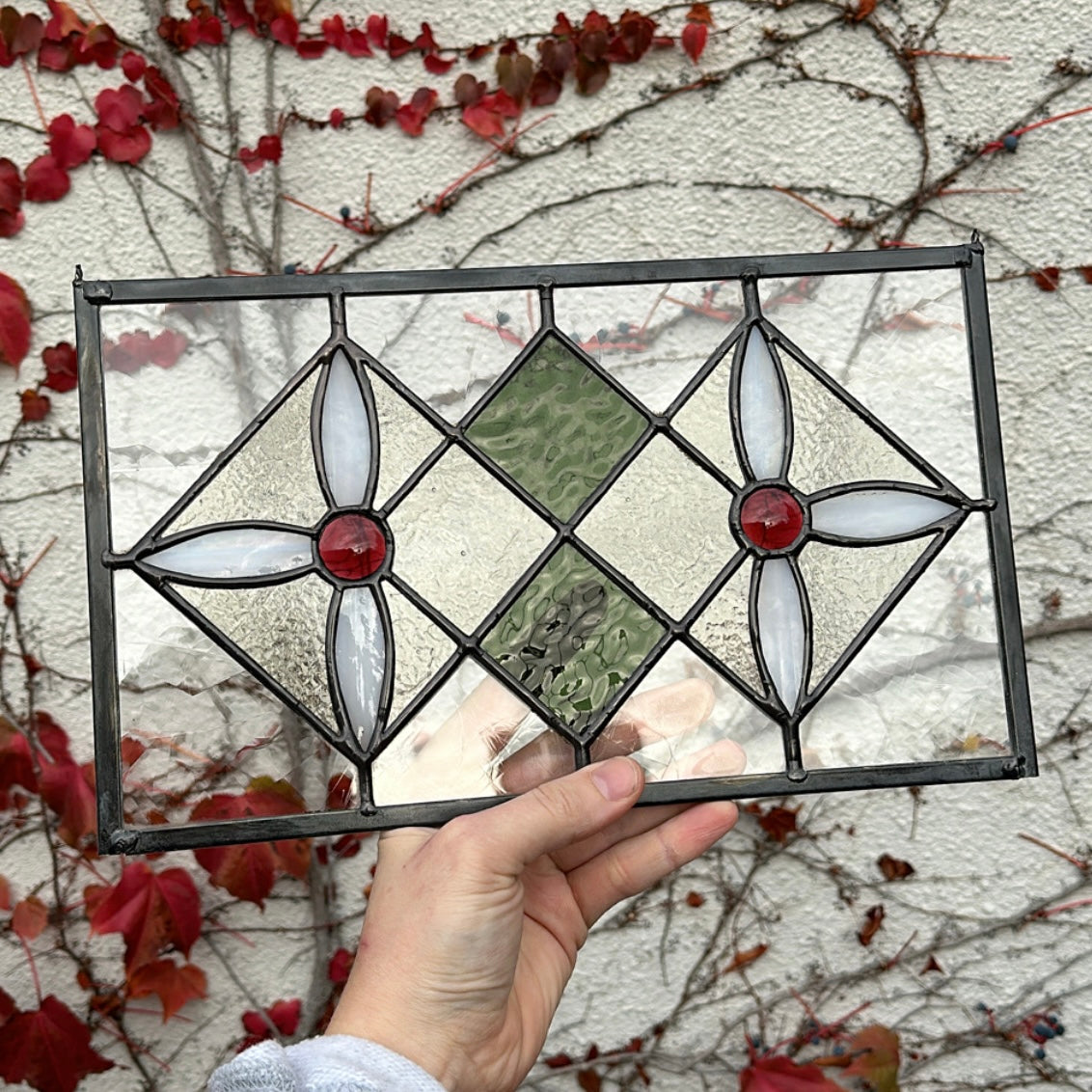 A floral geometric stained glass window.
