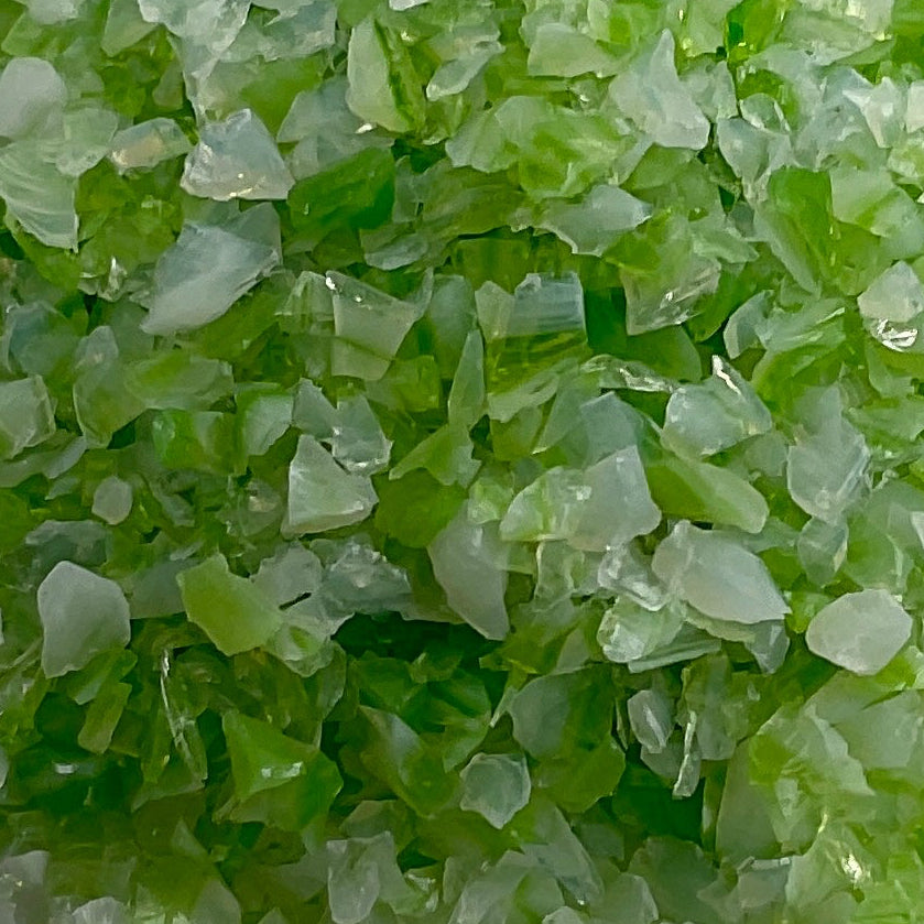 Green crystal-like substance on a gray background