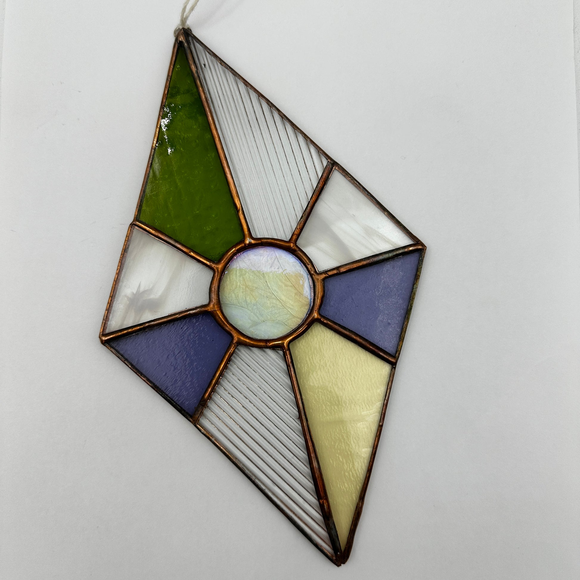 Stained glass panel with geometric design on a white background