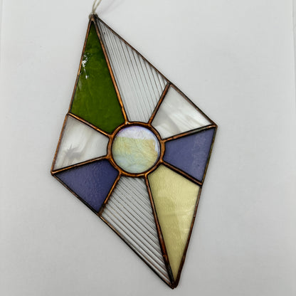 Stained glass panel with geometric design on a white background