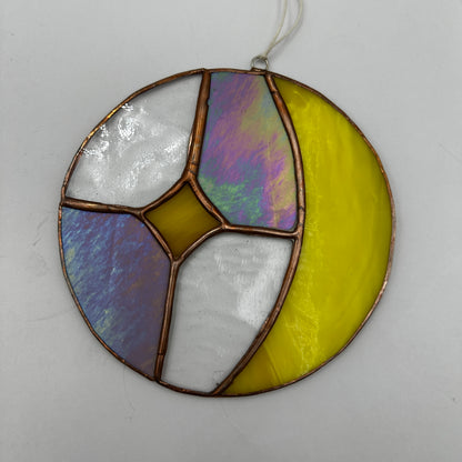 Stained glass circular panel with colorful segments on a white background