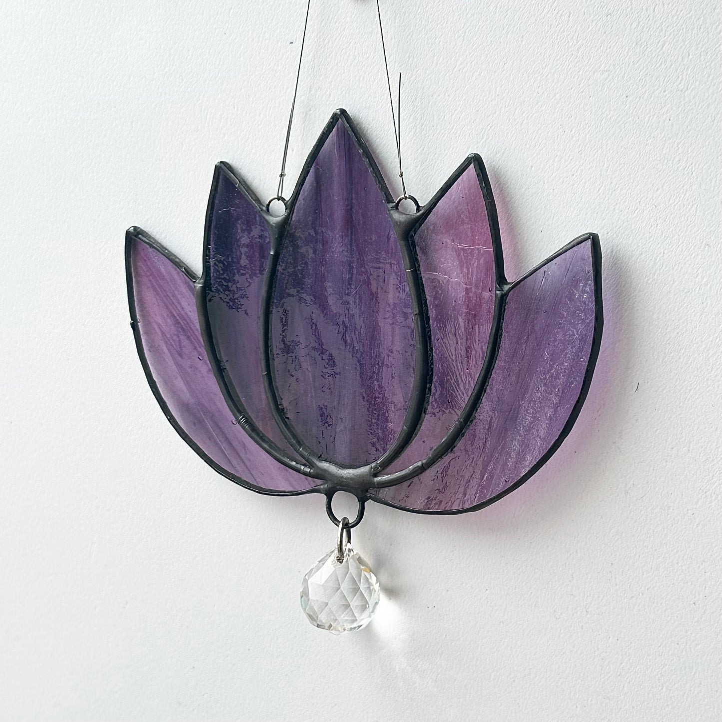 Stained glass sun catcher of a lotus flower.
