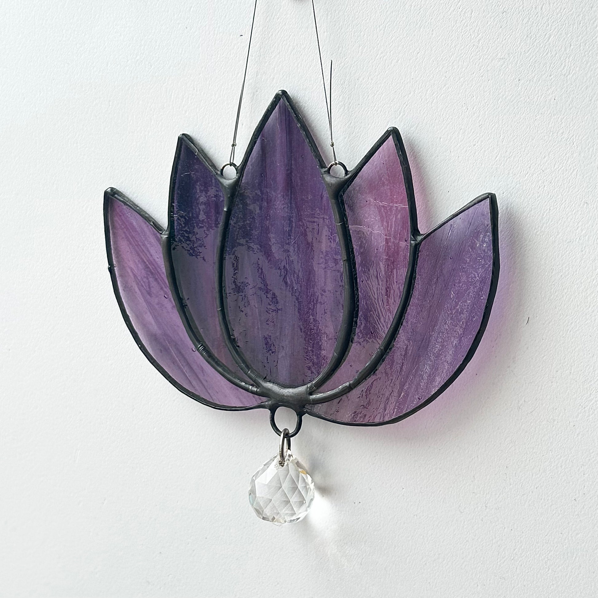 Stained glass sun catcher of a lotus flower.