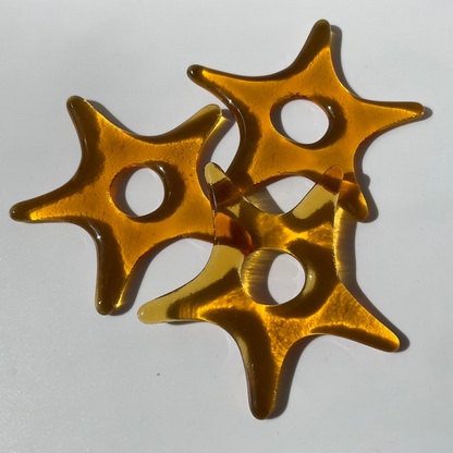 Three amber fused glass ornaments.