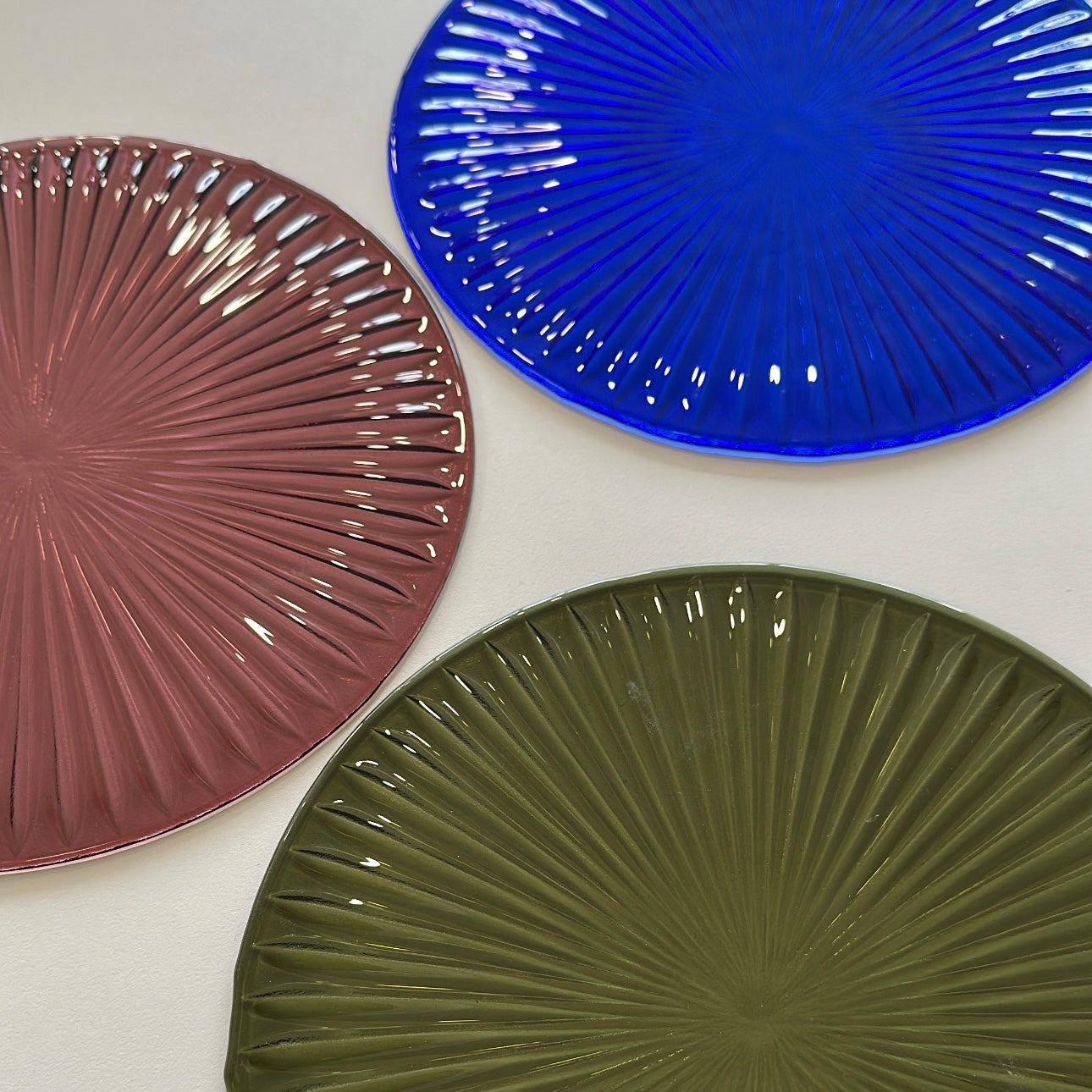 Three textured fused glass starburst circles in purple, blue and green.