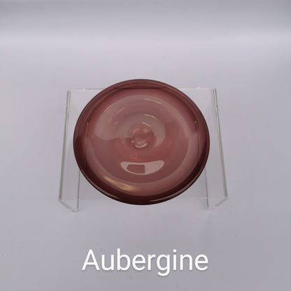 A purple glass rondel for stained glass work.