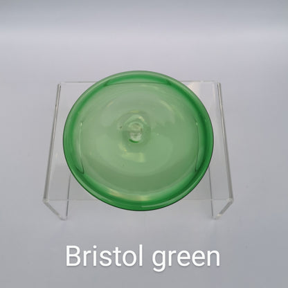 A green hand blown glass rondel for stained glass work.