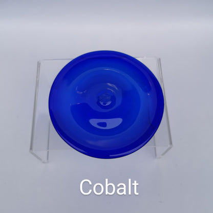 A cobalt blue hand blown glass rondel for stained glass work.