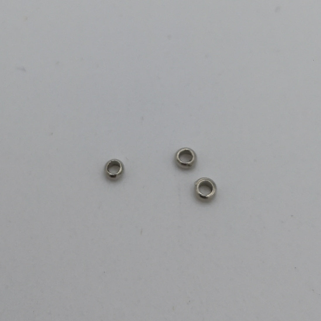 Three small crimp beads for hanging small stained glass pieces.