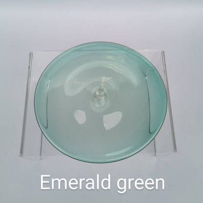 An emerald green hand blown glass rondel for stained glass work.