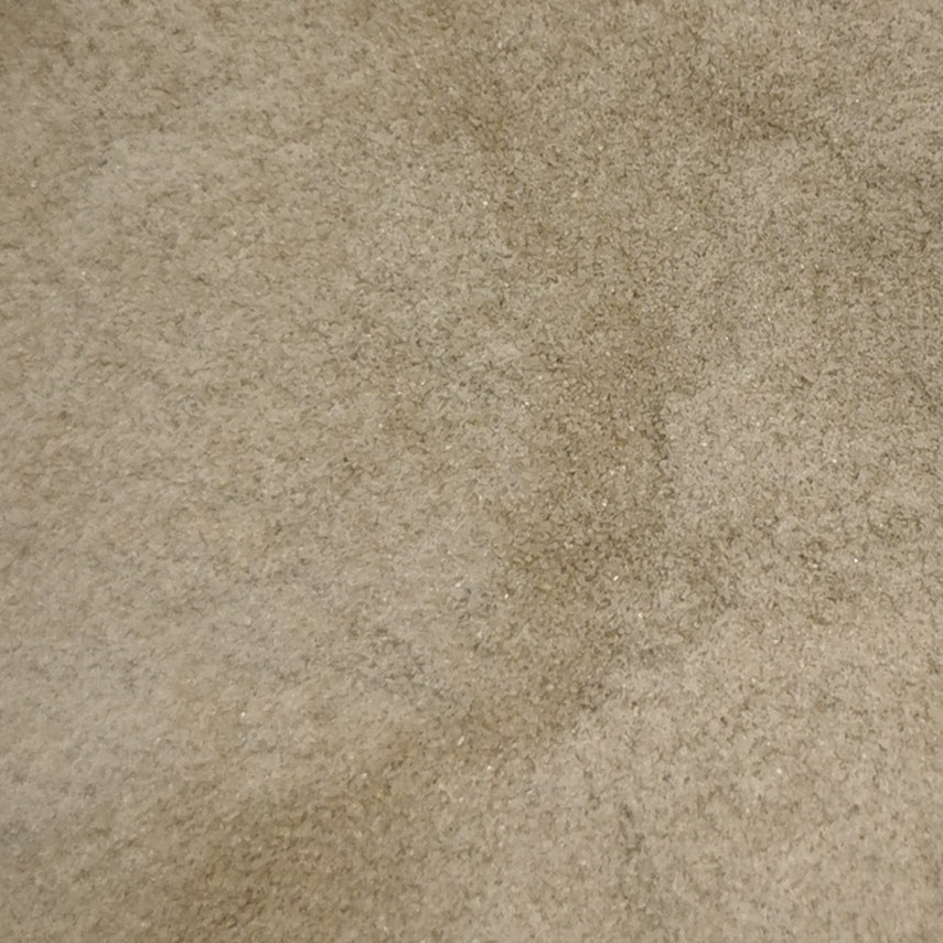 Close-up view of an 8oz bottle of OGT Chocolate Opal System 96 frit, displaying a beige-colored textured surface.