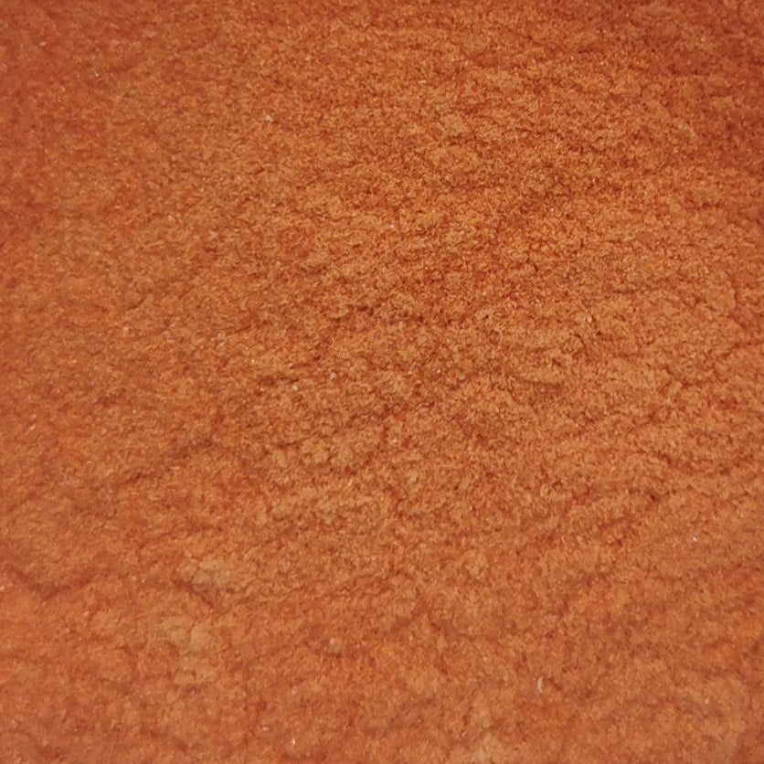 Close-up of red opalescent glass frit.