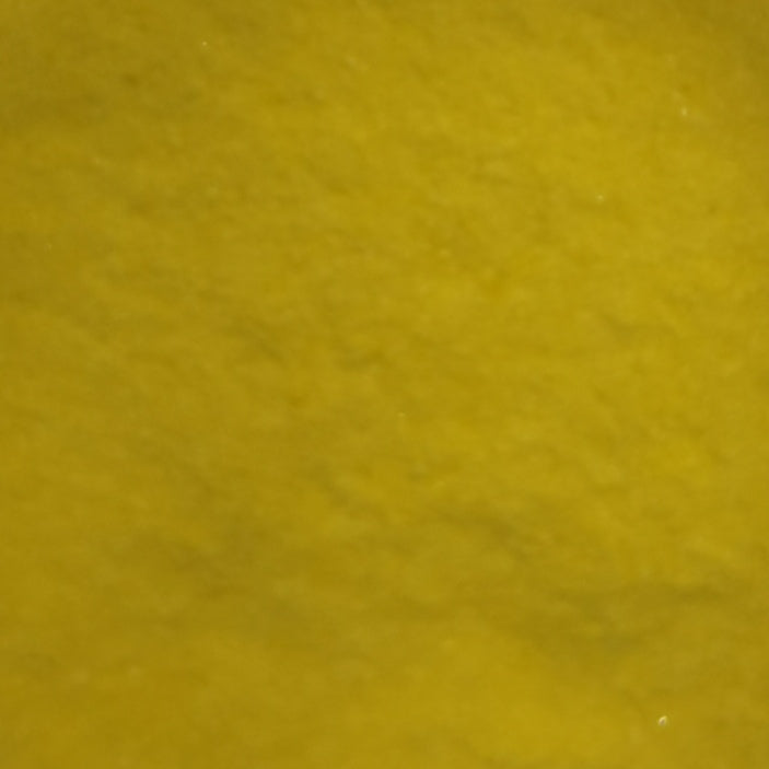 Close-up of yellow opalescent glass frit.